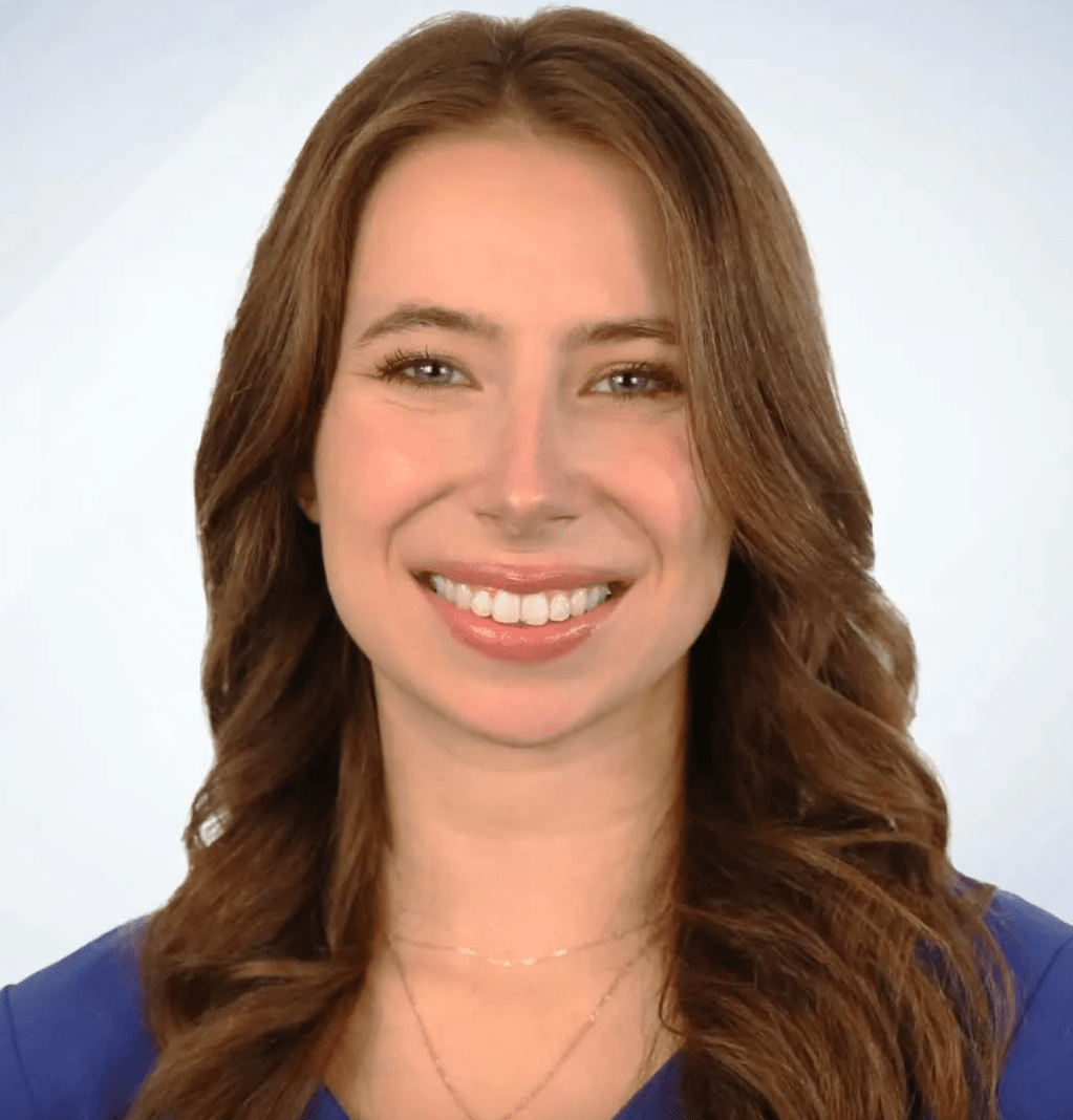 A headshot of Leah Crowley against a gray background.